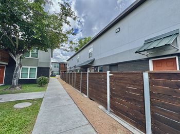 A long wooden fence runs down the side of a building.