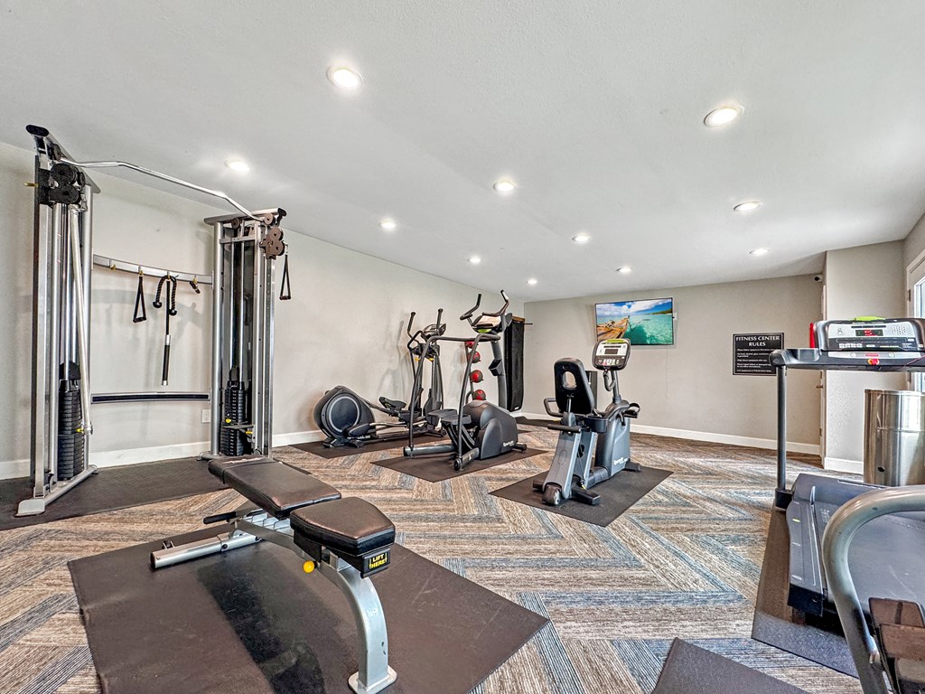 Strength training machines in the fitness center at Towne Oaks Apartments.