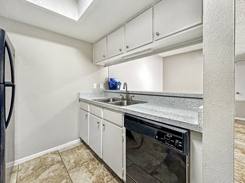 A kitchen with a stainless steel oven and a sink.