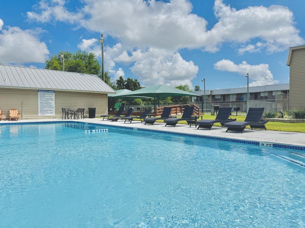 Resort-style pool with lounge chairs – Borders Apartments Brownsville TX