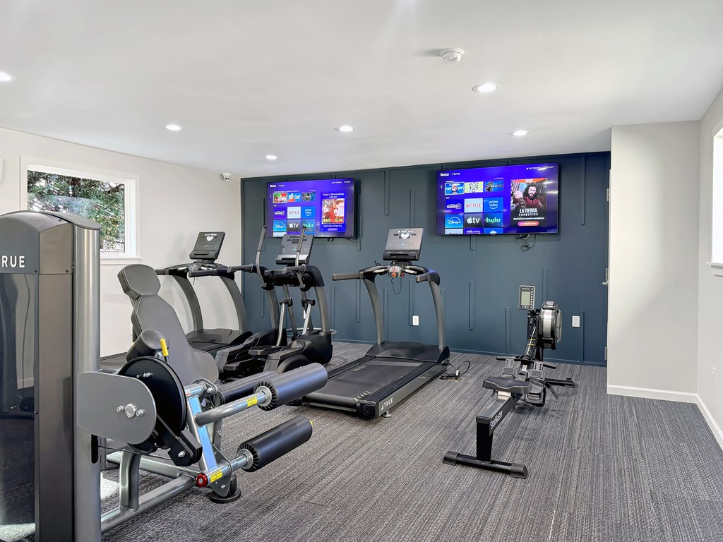 Fitness center with treadmills and cardio equipment at Station 121 Apartments