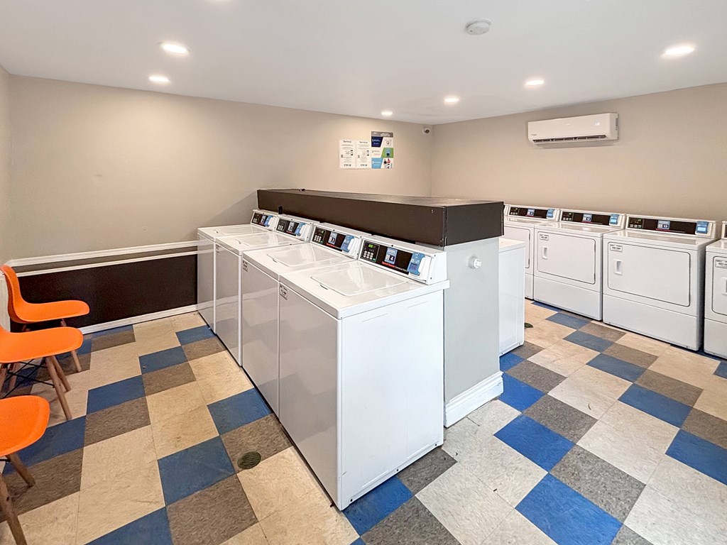 Laundry room with washers and dryers at Christy Estates Apartments