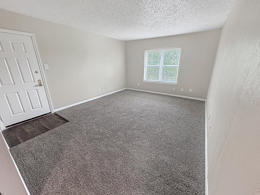 Bedroom with carpet flooring and bright window at Christy Estates Apartments