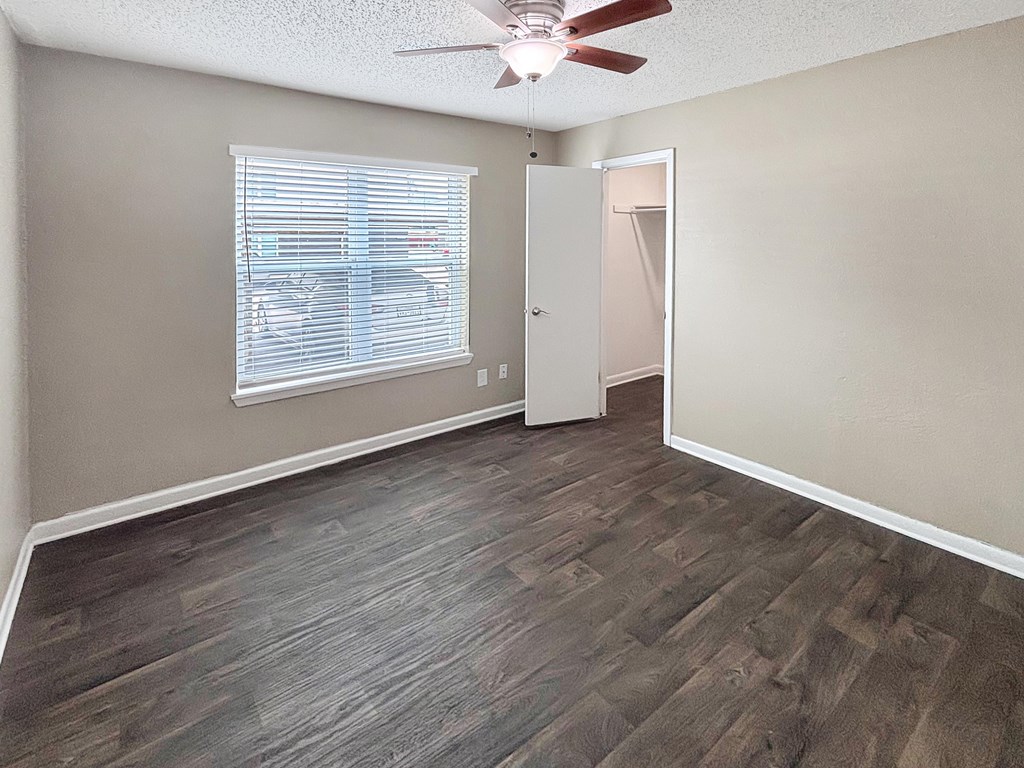 Bedroom with ceiling fan and single window at Christy Estates Apartments