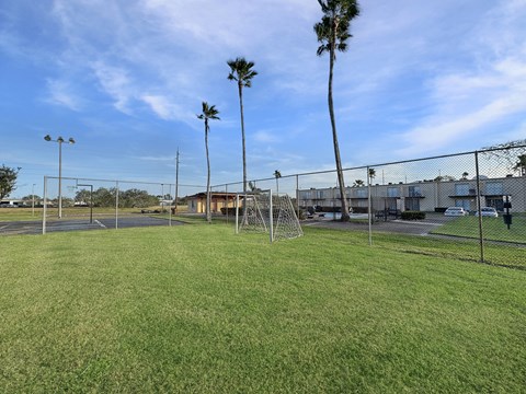 Community soccer field with goalposts at Los Cedros Apartments