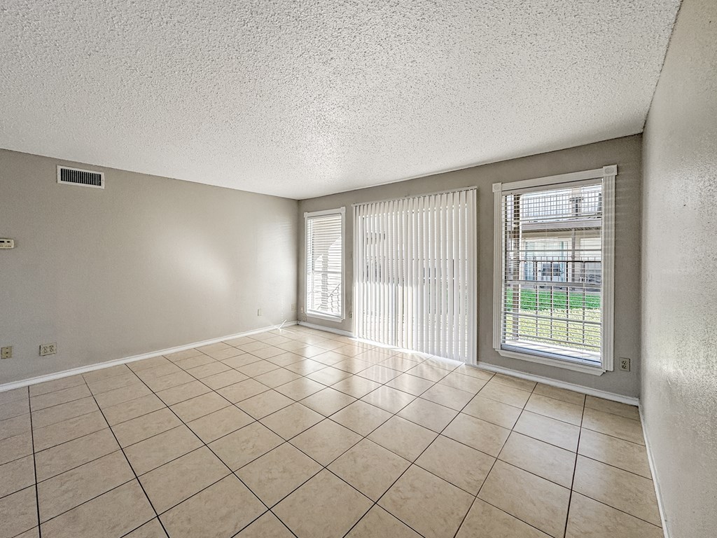 Tile floor living room with sliding patio door – Borders Apartments Brownsville TX