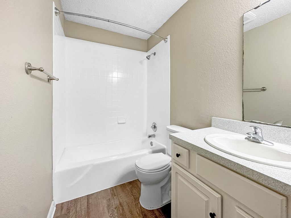 Bathroom with tiled shower and vanity storage at Verano Oaks Apartments in Hurst