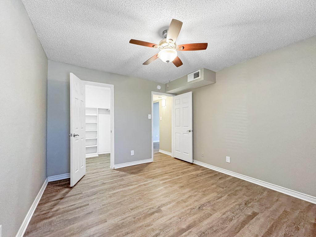 Bedroom with closet doors and light neutral walls in Verano Oaks Apartments