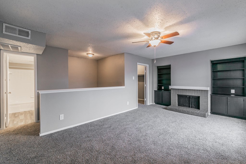 Bedroom with neutral tones, ceiling fan, and natural light at Station 121 Apartments