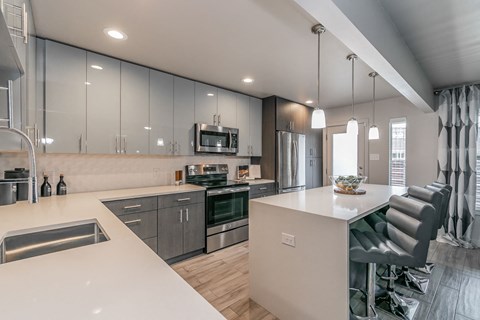 a kitchen with an island and a stove and a refrigerator