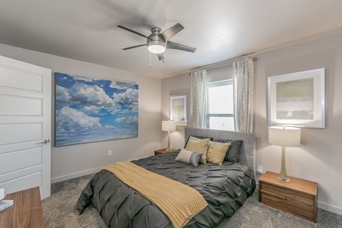 Stylish bedroom with ceiling fan and natural light at Reserve on Abrams Dallas