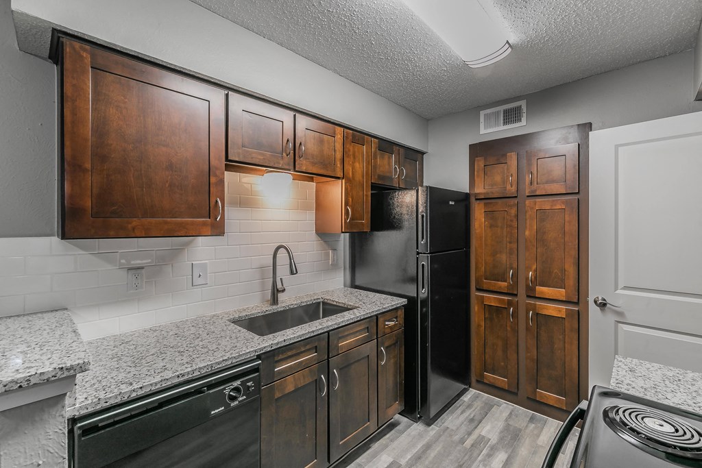 Kitchen with wood cabinetry and upgraded counters