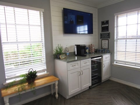 a kitchen with a counter and a tv on the wall