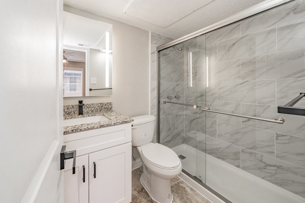 Contemporary bathroom with large mirror and modern lighting