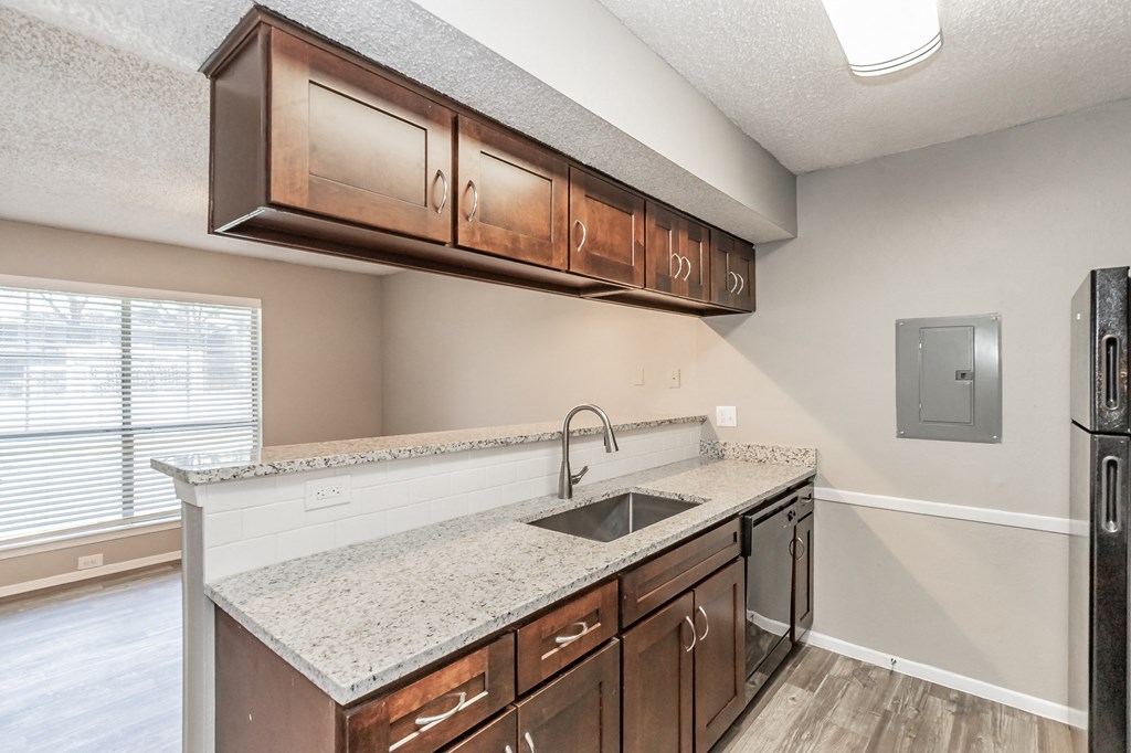 Kitchen with wood cabinetry and upgraded counters