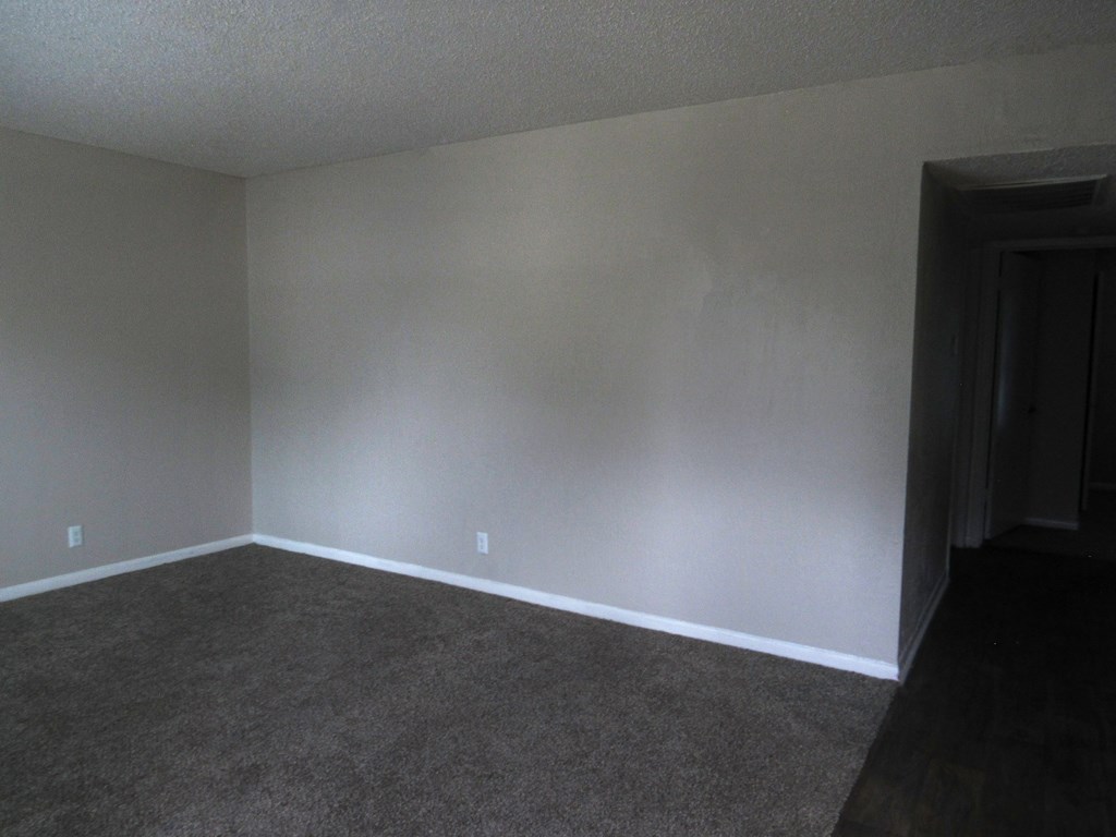 an empty room with carpet and a door