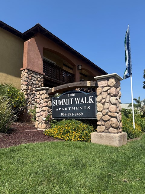 A sign for Summit Walk Apartments is in front of a building.