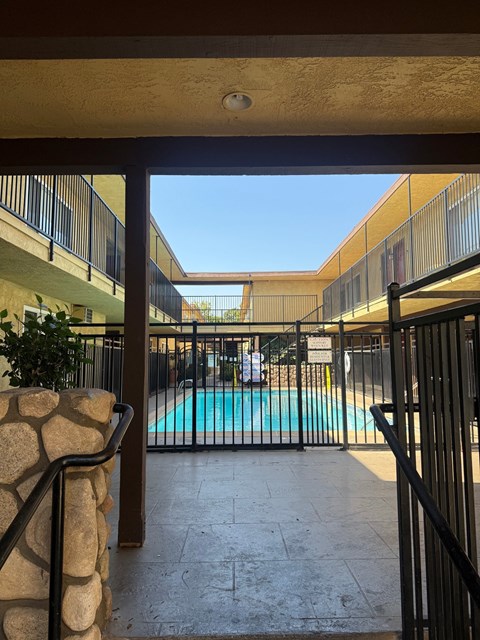 A pool is seen through a gate.