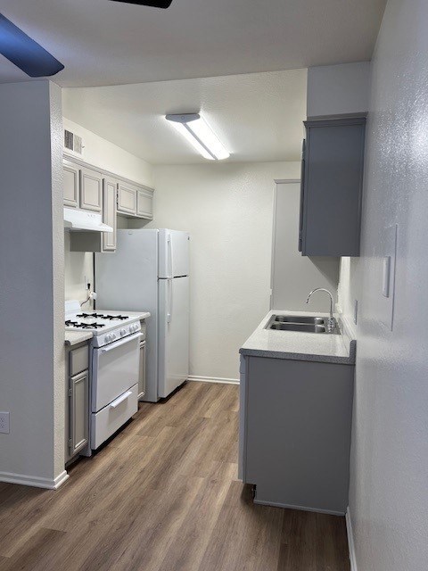 A small kitchen with a stove and a sink.