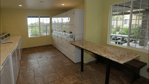 a large kitchen with a counters and a table