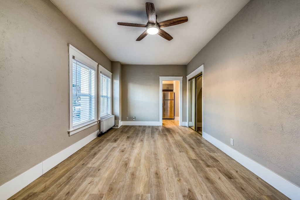 a living room with hardwood floors and a ceiling fan