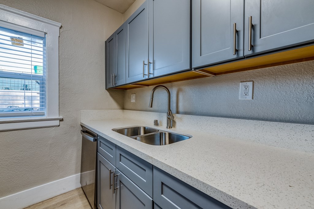 a kitchen with a sink and a window
