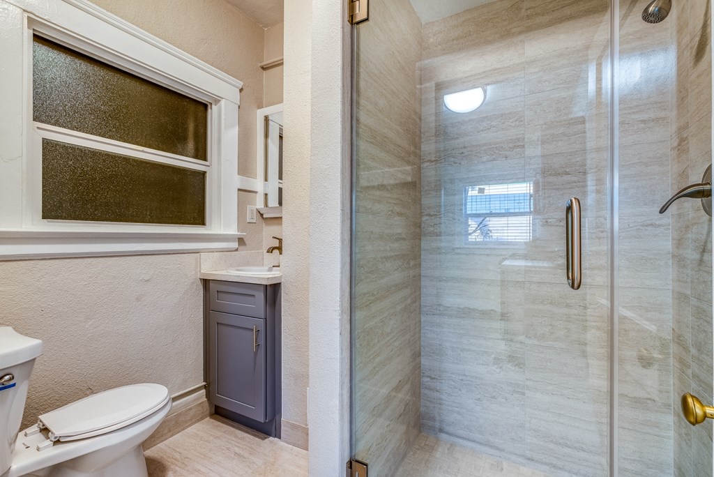 a bathroom with a toilet sink and shower