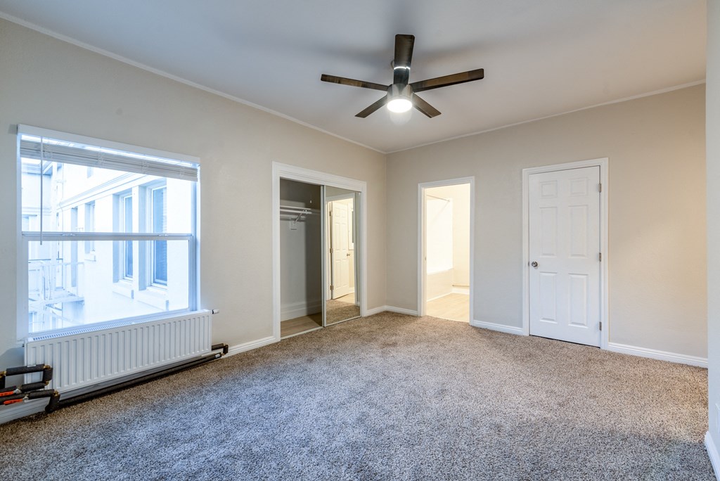a living room with a ceiling fan and a window