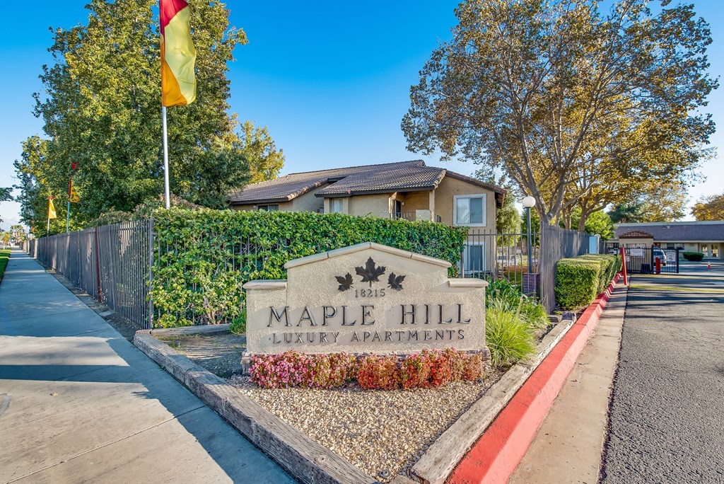 an image of the maple hill apartments sign in front of the building