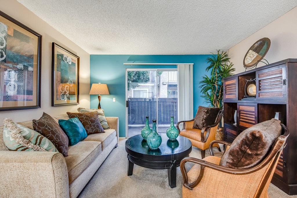 a living room filled with furniture and a large window