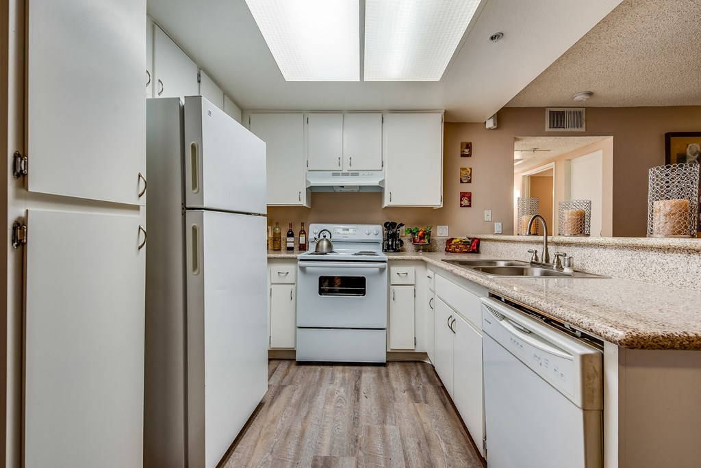 a kitchen with white cabinets and white appliances