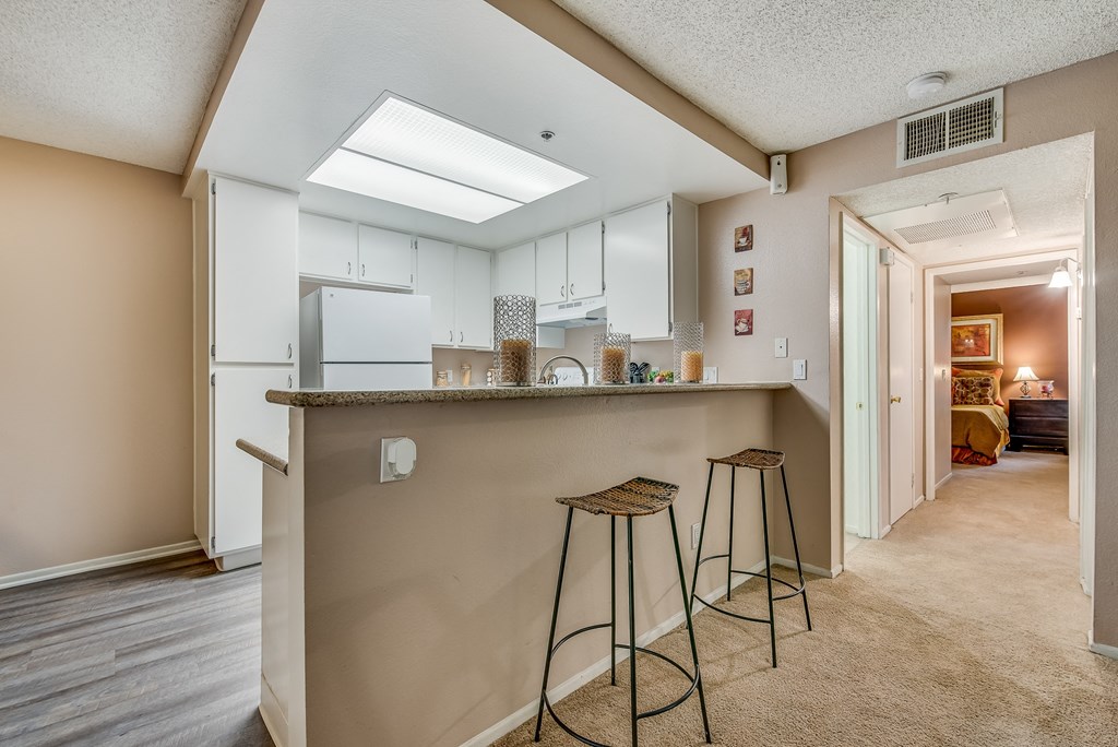 a kitchen with a breakfast bar and stools