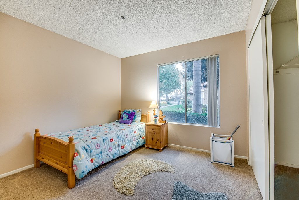 a bedroom with a bed and a window