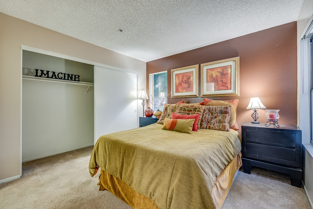 a bedroom with a bed and two nightstands