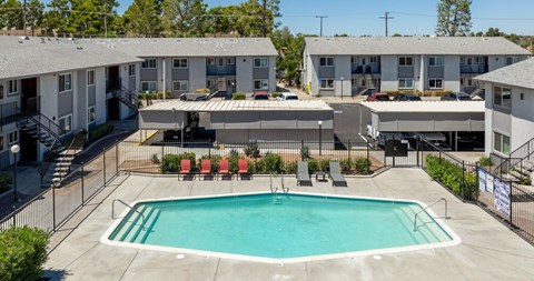 A swimming pool in front of apartment buildings.