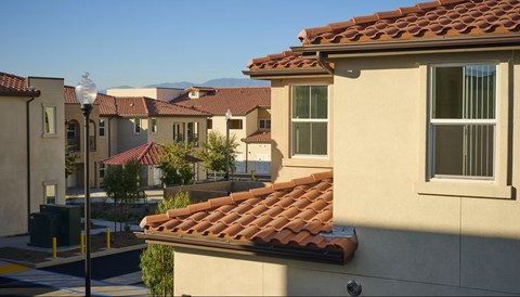 A row of houses with red tile roofs.