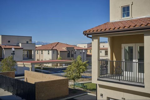 A row of houses with a mountain in the background.