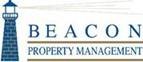 A lighthouse is pictured on a sign for Beacon Property Management.