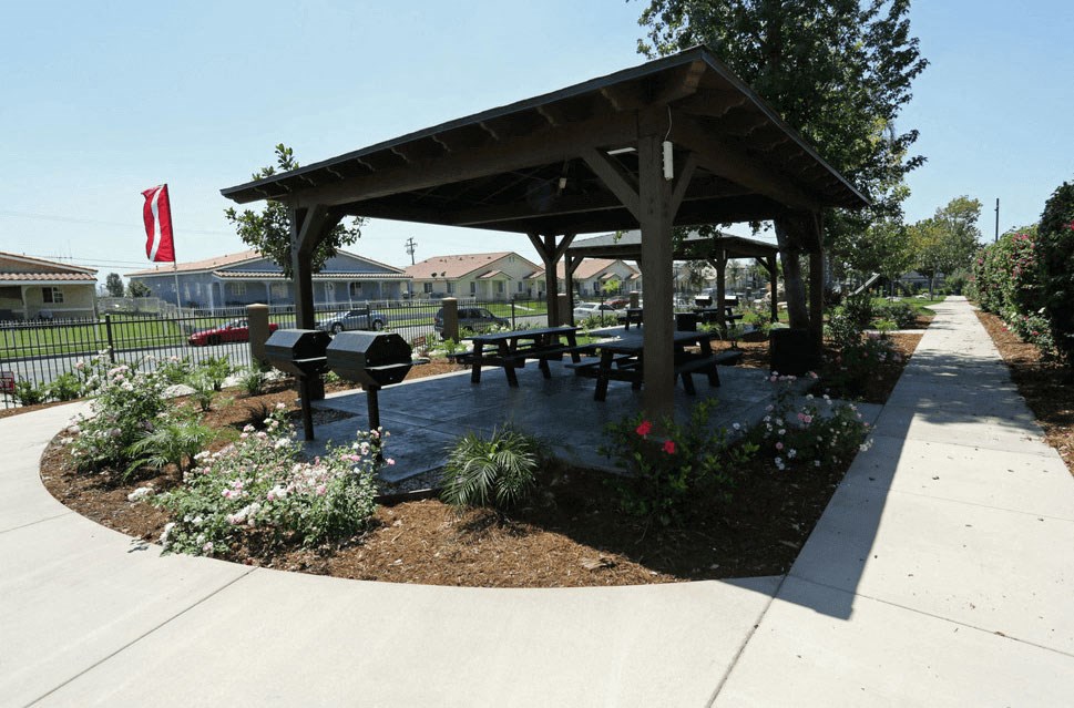a picnic shelter with benches and a grill