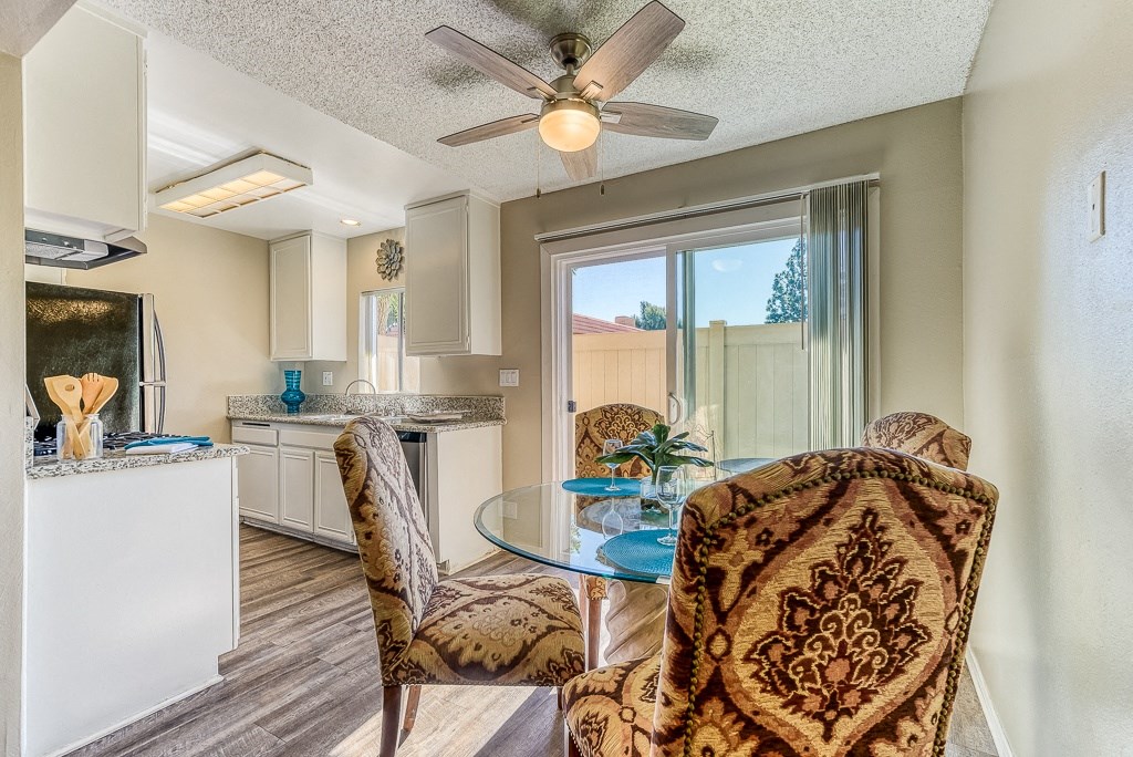 A living room with a brown patterned chair and a glass table.