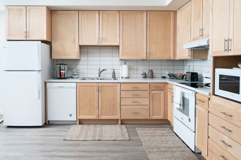 A kitchen with wooden cabinets and white appliances.