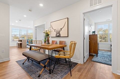 Dining room table surrounded by chairs and a bench in Bala Cynwyd, PA apartment for rent