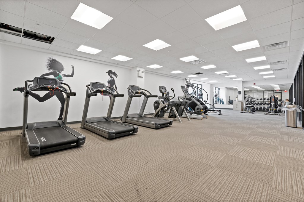 Cardio machines in spacious, student apartment fitness center
