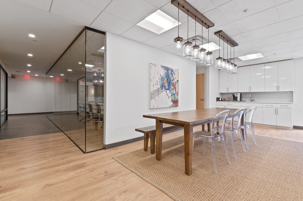 Open study room with large table surrounded by chairs and coffee bar