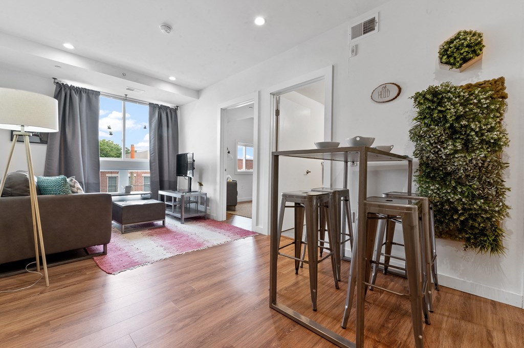 Living and dining area with hardwood flooring and large window for lots of natural light