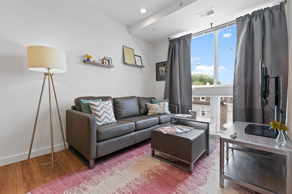 Furnished student apartment in University City with cozy leather couch next to large window
