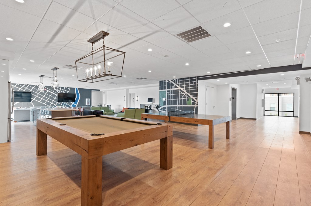 Gorgeous wood pool table under contemporary lighting in resident lounge at UCity Flats