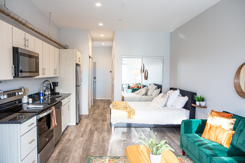 Guest Suite a bedroom with a bed and a kitchen and a living room