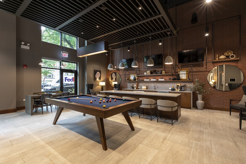 a games room with a pool table and a bar