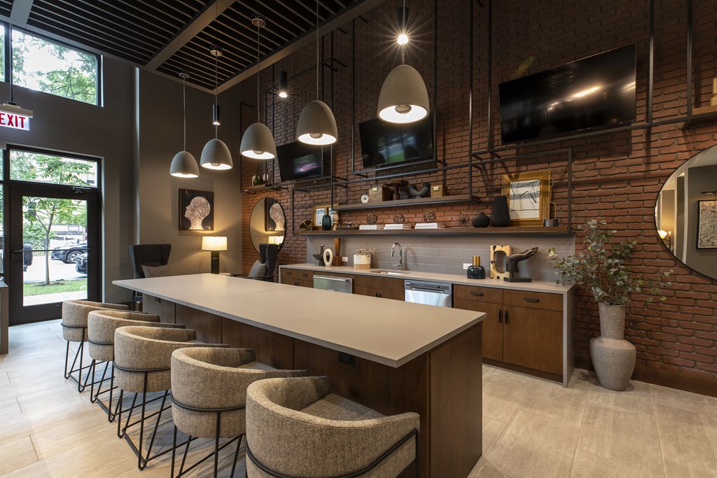 a restaurant with a long bar and chairs and a tv on the wall